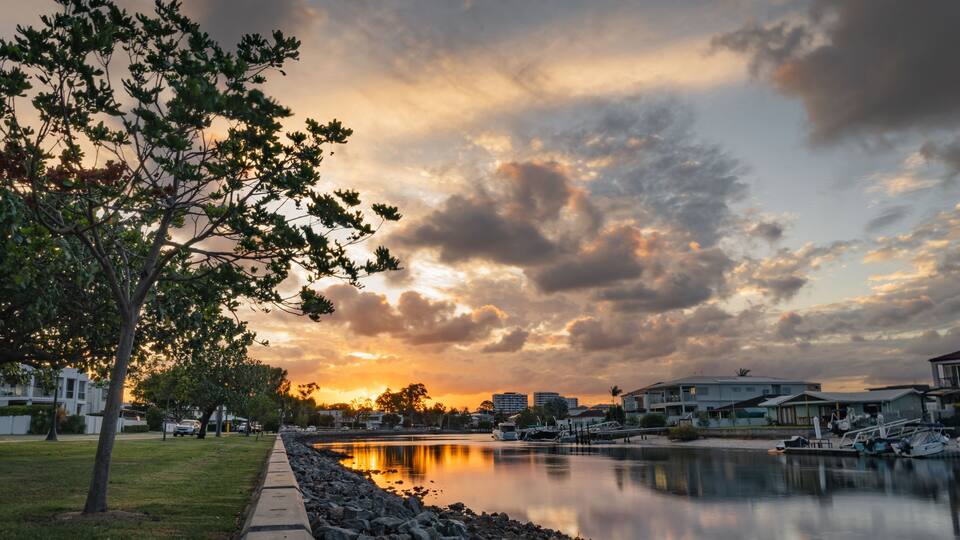 Picturesque scene of an urban area of Queensland, Australia at sunset, taken from the edge of river