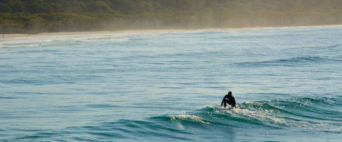 North Stradbroke Island which includes surfing, surf and a sunset