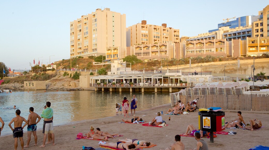 St George\'s Beach featuring a coastal town and a beach as well as a large group of people