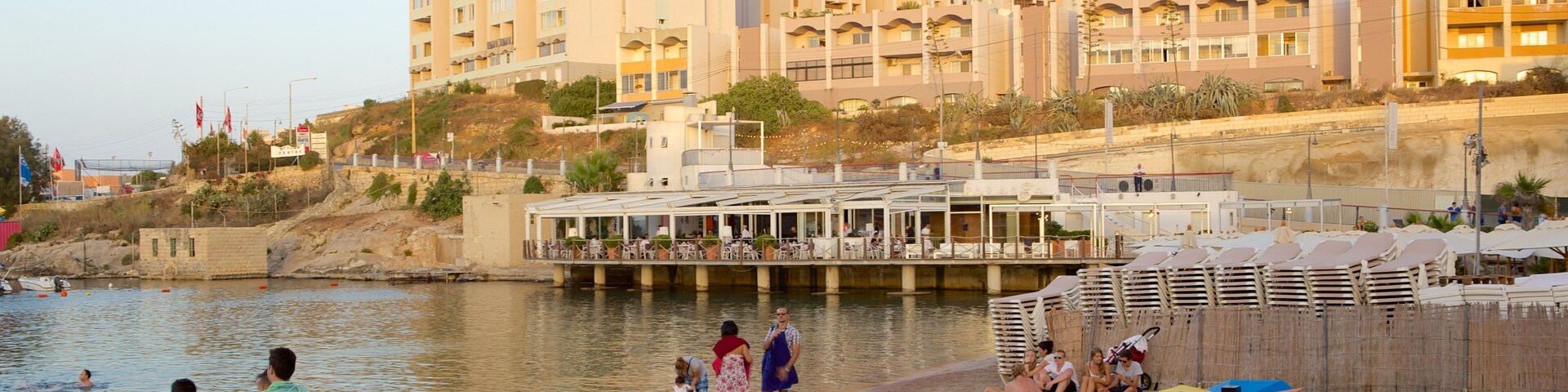 St George\'s Beach showing a coastal town and a beach as well as a large group of people