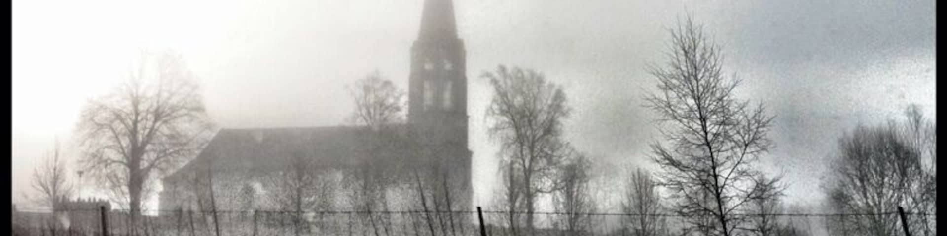 Skallsjö church a cold and foggy morning. The tower is built similar to a lighthouse.