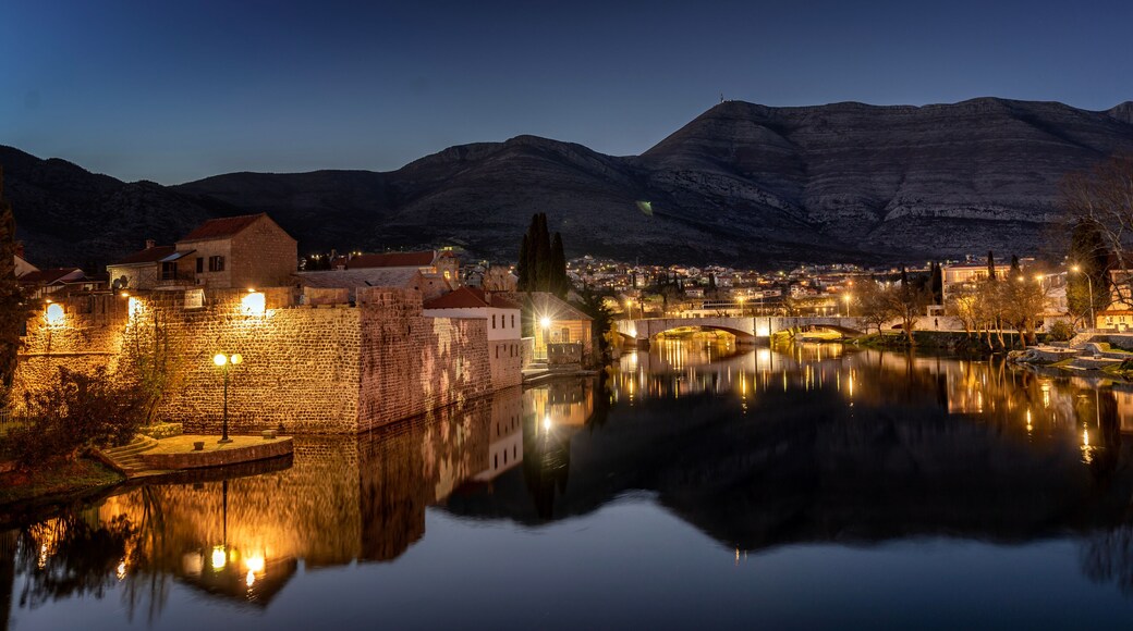 Night cityscape. Trebinje is a city in Bosnia and Herzegovina, the historical center of the city. Buildings are reflected in the river