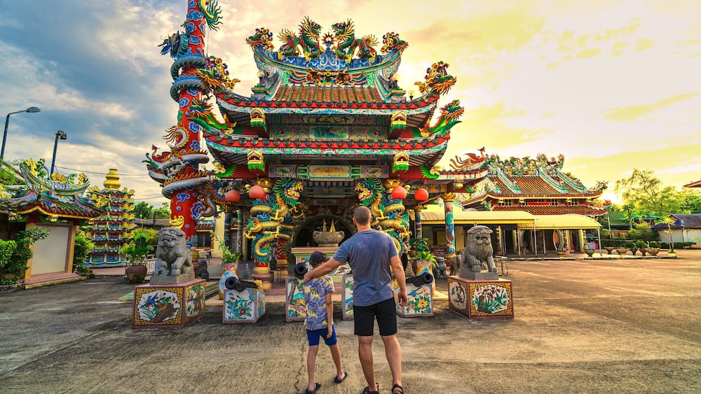 A traditional ornate temple with intricate architecture and lion statues.