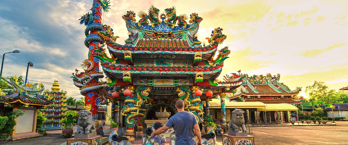 A traditional ornate temple with intricate architecture and lion statues.