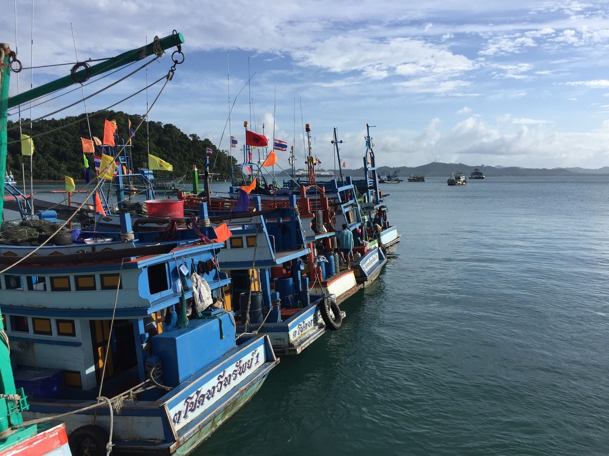 Fishing boats lined up at Ao Sapparot pier on Koh Chang island in Trat province of Thailand in a late morning.