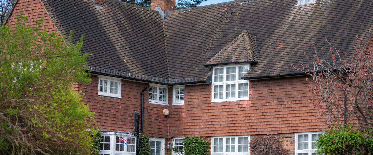 Walking on streets of North London, red brick houses and flowering gardens in spring, city life, wealthy neighbourhoods in London, UK