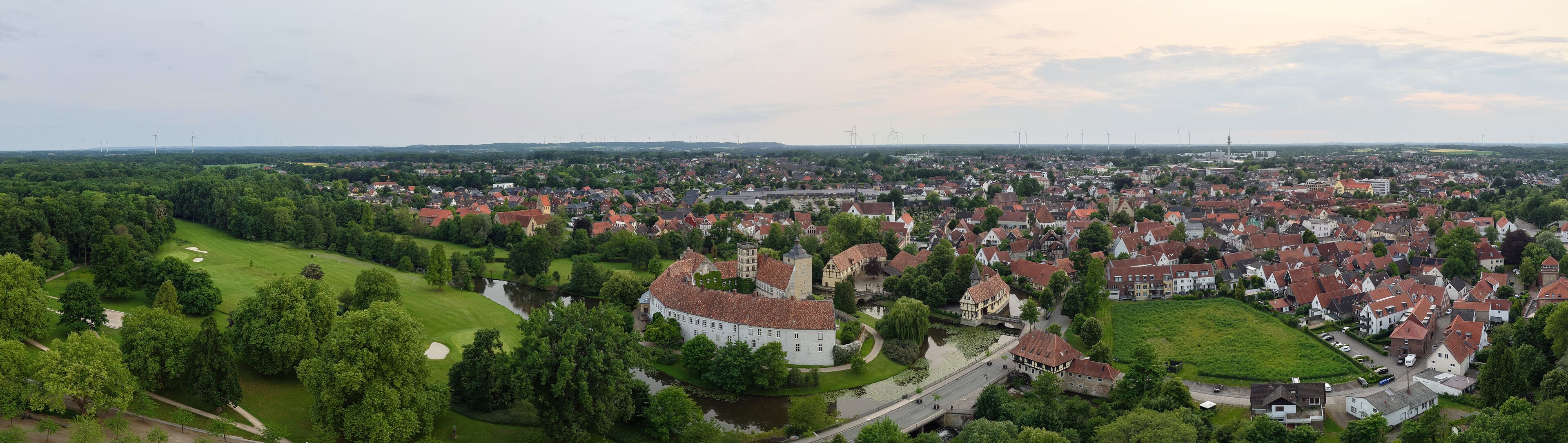 A panoramic drone view of the city and the castle, which sits on the water, in Steinfurt, Germany (Wasserschloss Burgsteinfurt)
