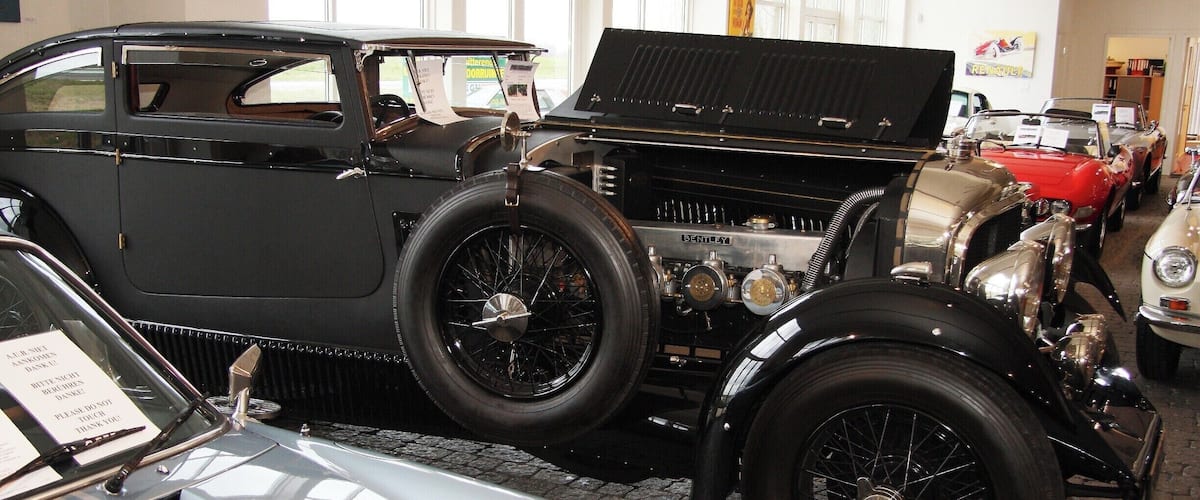 A vintage car exhibition with classic cars on display.