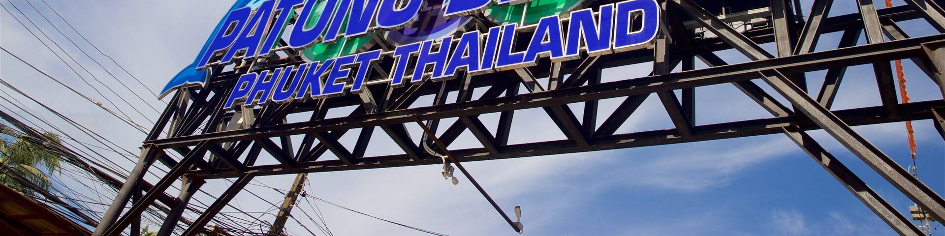 A colorful sign with dolphins and the text "PATONG BEACH PHUKET THAILAND".