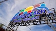 A colorful sign with dolphins and the text "PATONG BEACH PHUKET THAILAND".