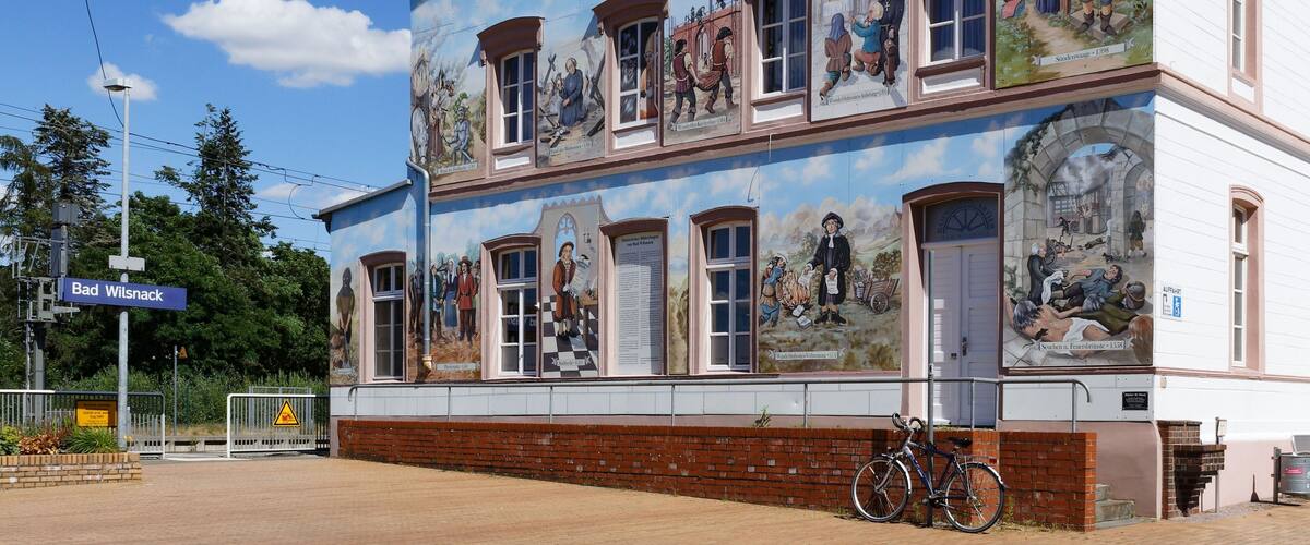 A building with a mural depicting historical scenes.