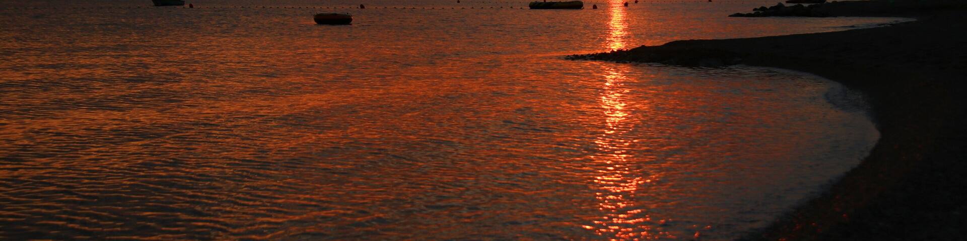 Sandy beach with sunset sky on Adriatic sea in Croatia