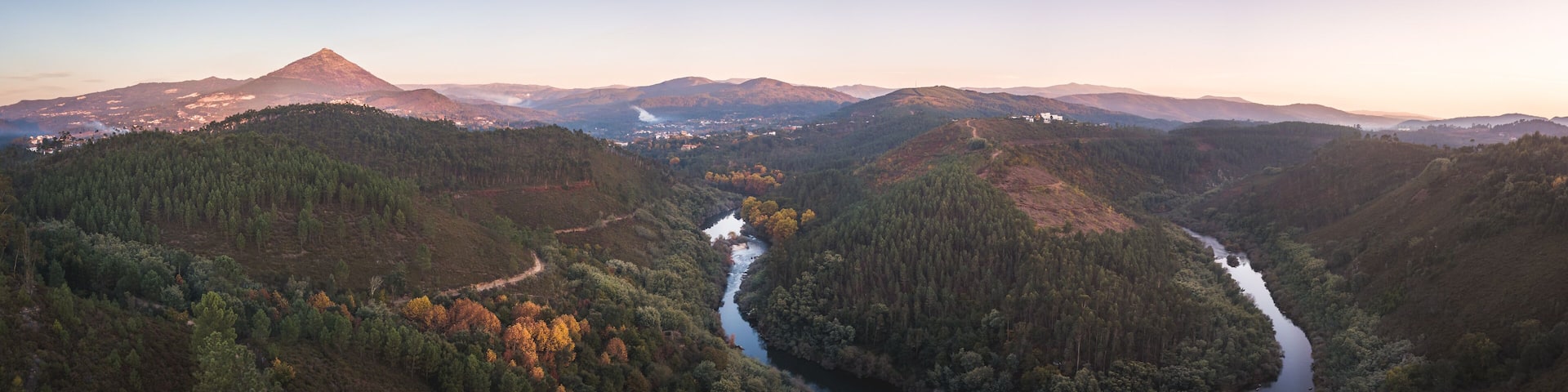A river winding through a valley with mountains in the background.