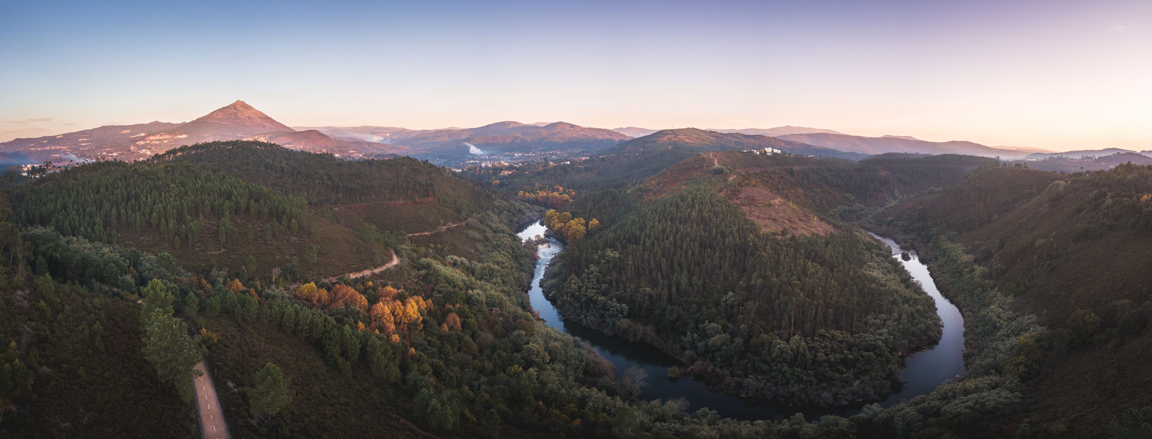 A river winding through a valley with mountains in the background.