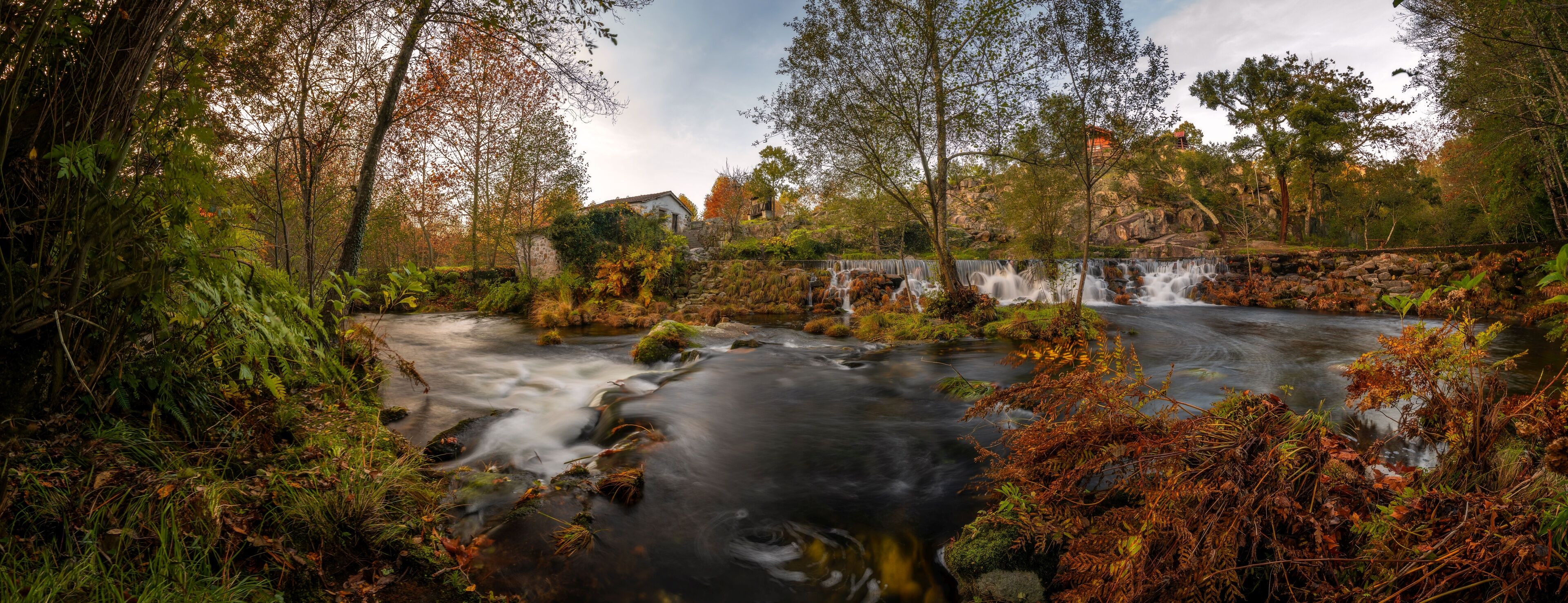 Mondim de Basto panorama waterfall with a mill house at sunset in Portugal
