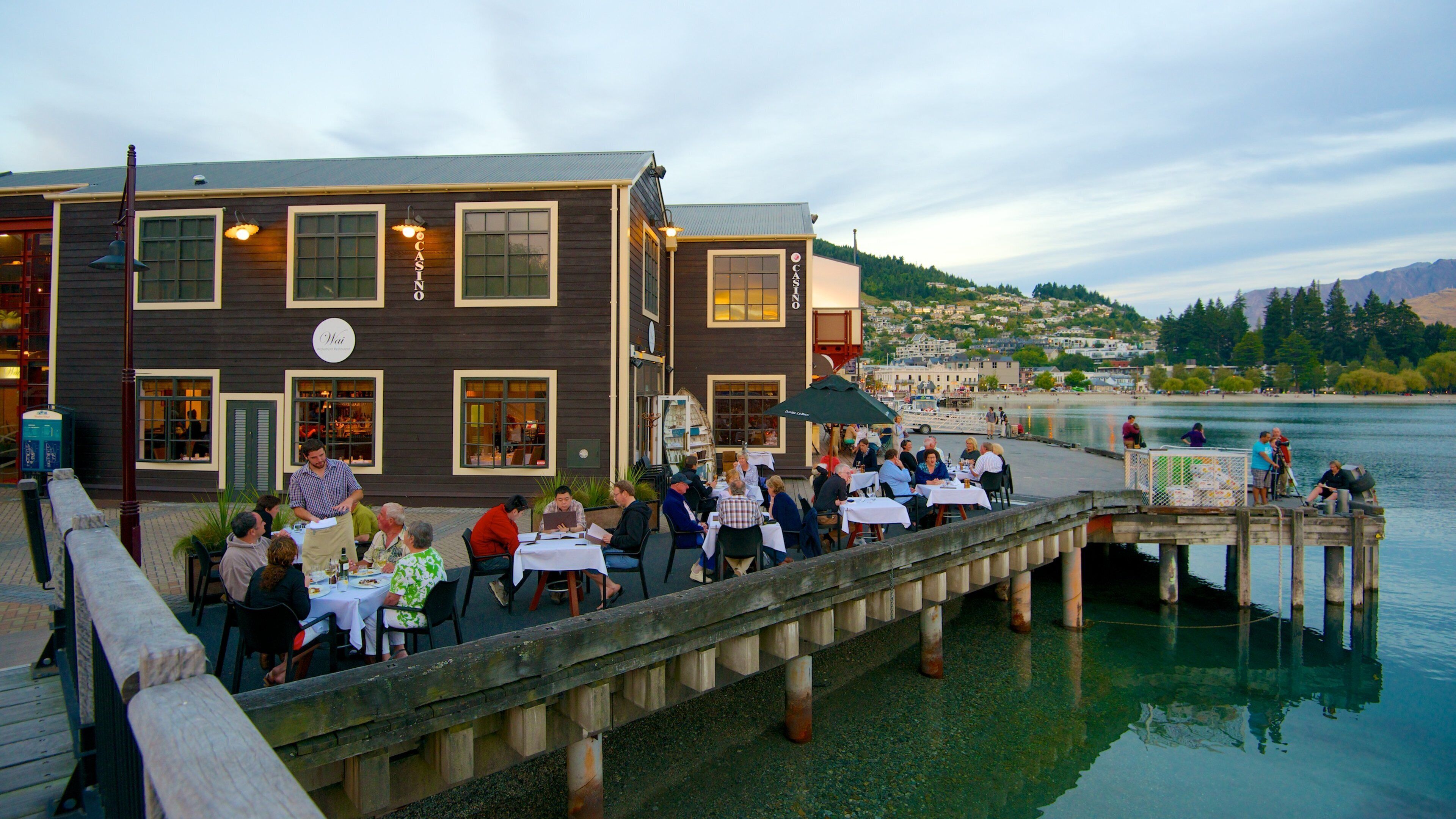 Steamer Wharf which includes general coastal views, a bay or harbor and outdoor eating