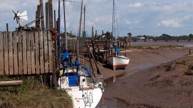 Boats moored at low tide