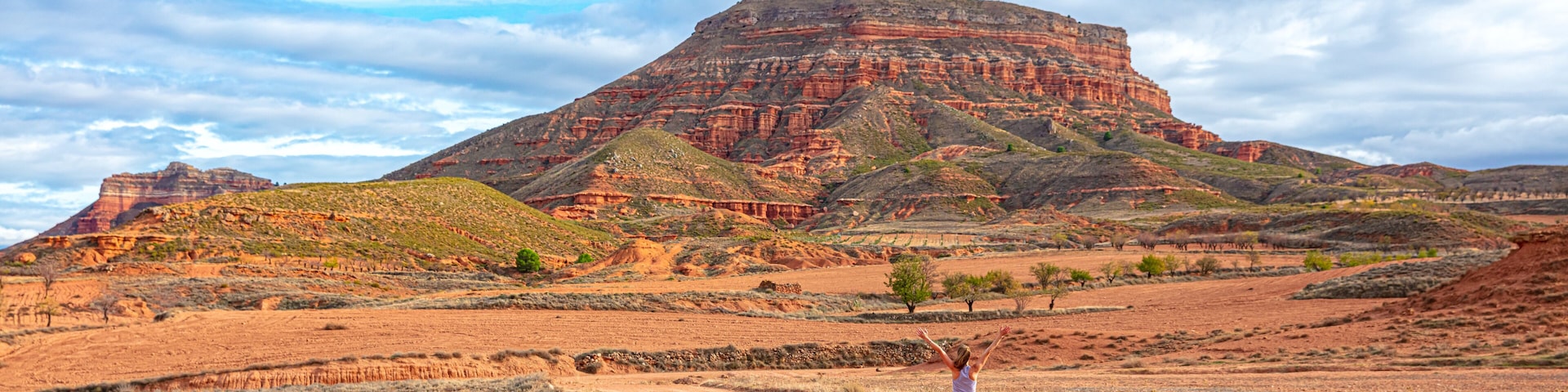Woman cyclist riding with mountain bike in the desert ( sierra armantes, Aragon in Spain- Zaragoza province)