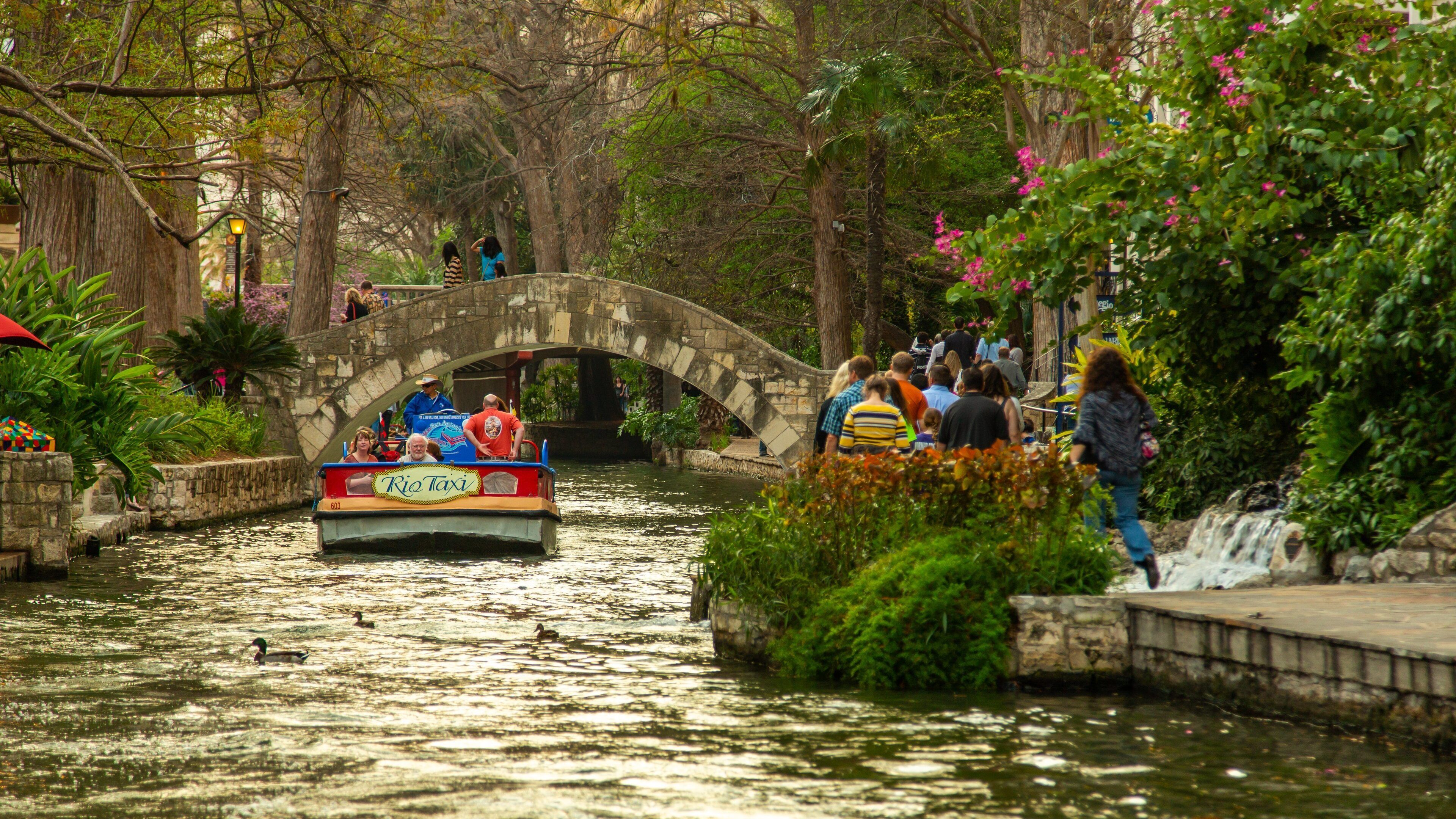River Walk showing a river or creek, a bridge and boating