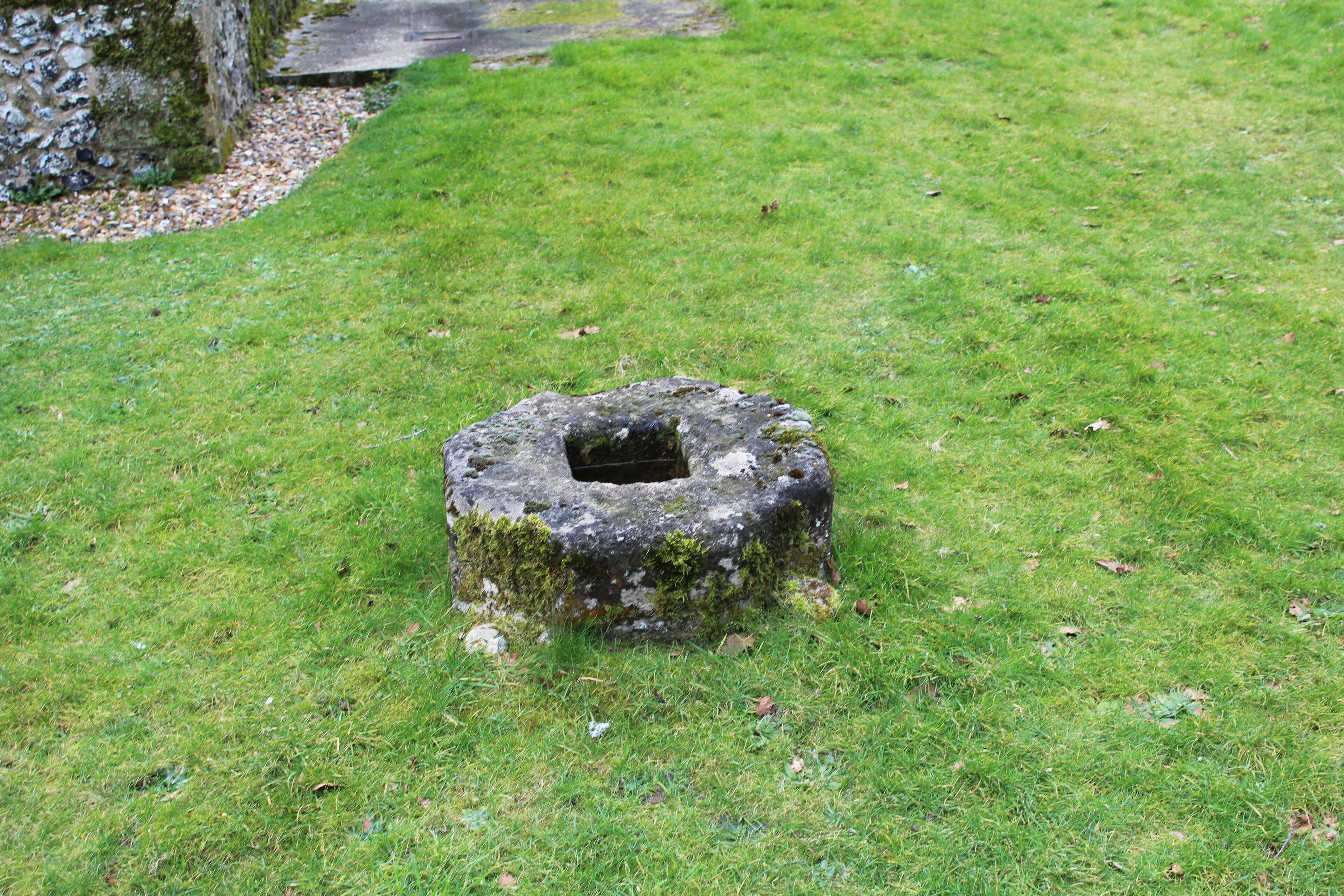 Medieval limestone cross-base 2 meters northwest of the Church of St Mary, Santon Downham, Suffolk.