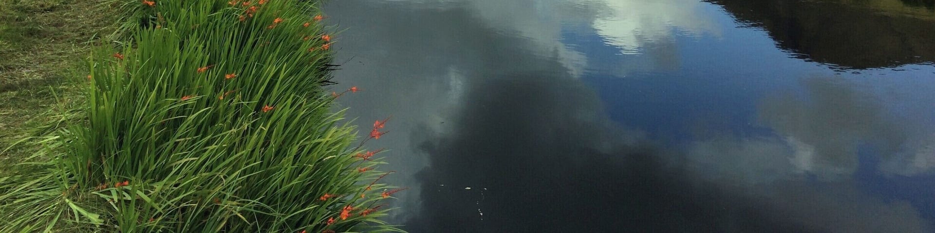 This is a peaceful and gentle sheltered river set in a mountainous and rugged landscape. A river, particularly loved by fishermen.