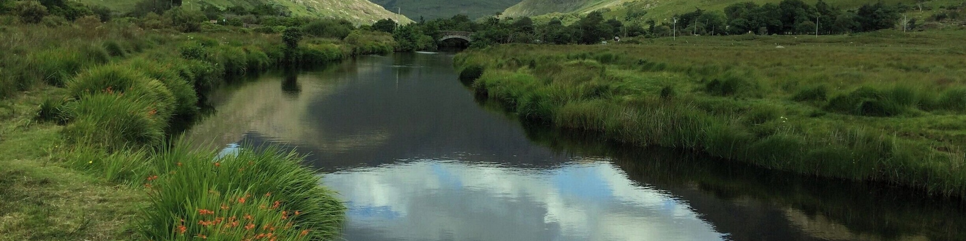 This is a peaceful and gentle sheltered river set in a mountainous and rugged landscape. A river, particularly loved by fishermen.