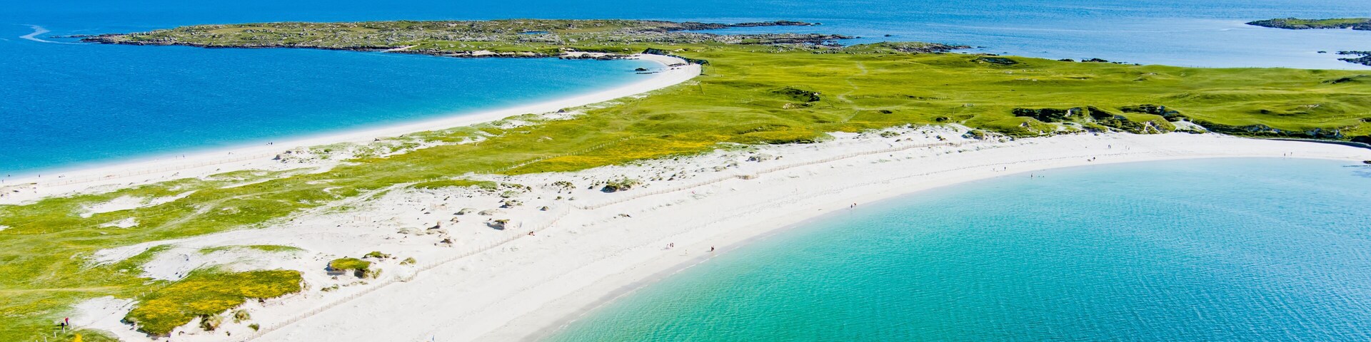 Aerial view of Dogs Bay and Gurteen Bay near Roundstone, Connemara, County Galway, Ireland. Scenic twin beaches with white sand and contrasting turquoise and blue Atlantic water.