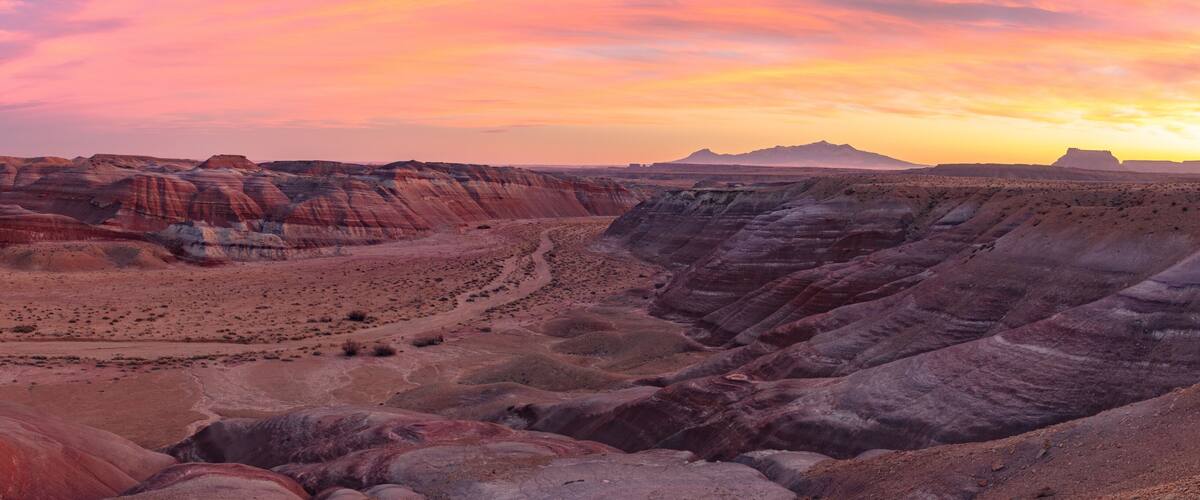 Beautiful Sunset in the desert Bentonite Hills of the southern San Rafael Swell near Hanksville Utah. In the distance from R/L: North Caineville Mesa, Factory Butte, and the Henry Mountains.