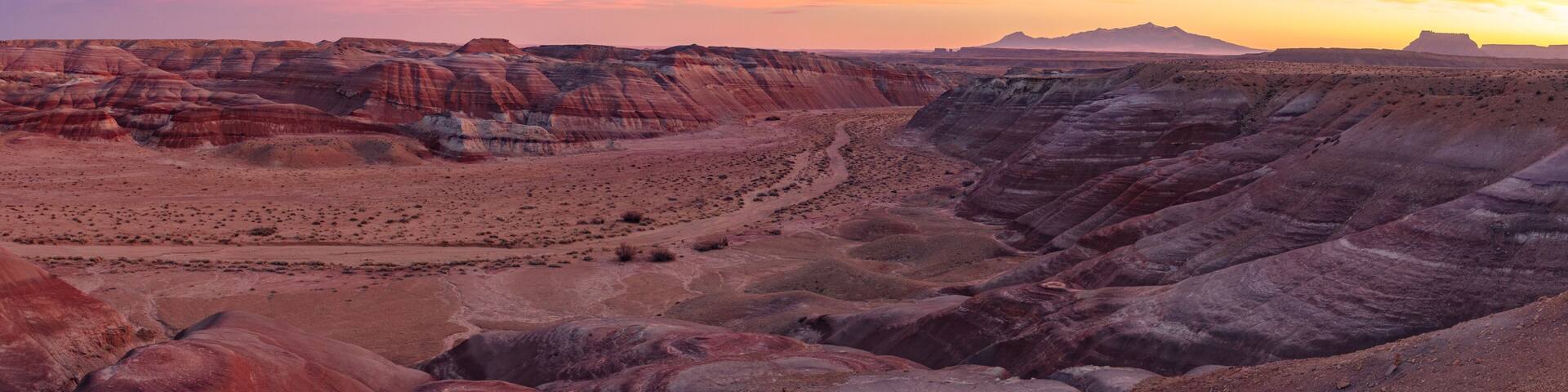 Beautiful Sunset in the desert Bentonite Hills of the southern San Rafael Swell near Hanksville Utah. In the distance from R/L: North Caineville Mesa, Factory Butte, and the Henry Mountains.