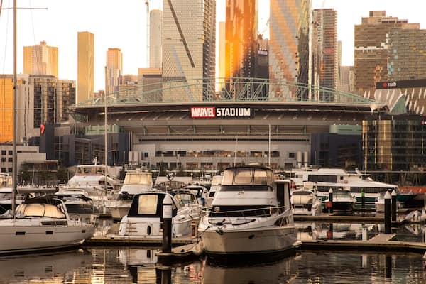 Marvel Stadium featuring a sunset, a bay or harbor and signage