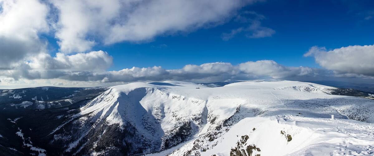 A snow-covered mountain range under a clear blue sky.