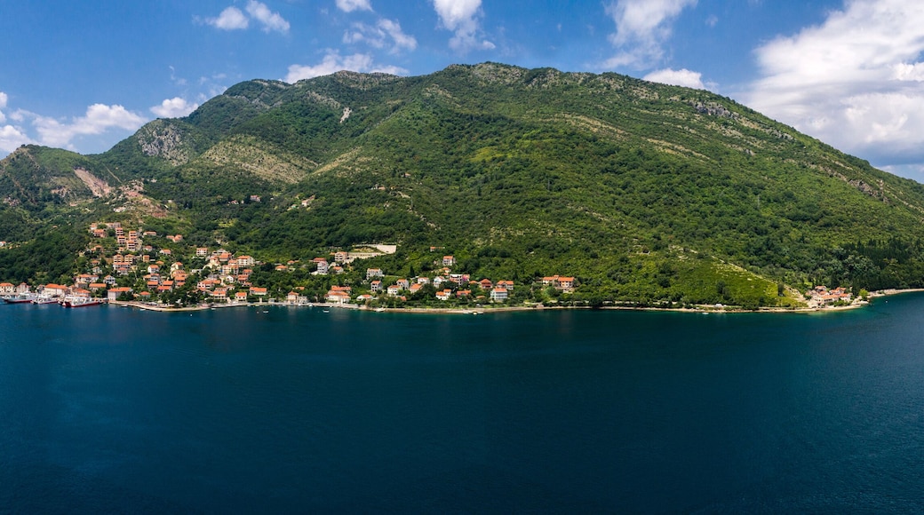 Aerial panoramic beautiful view from above to Kotor Bay and regular passenger ferry from Lepetane to Kamenari by a sunny afternoon