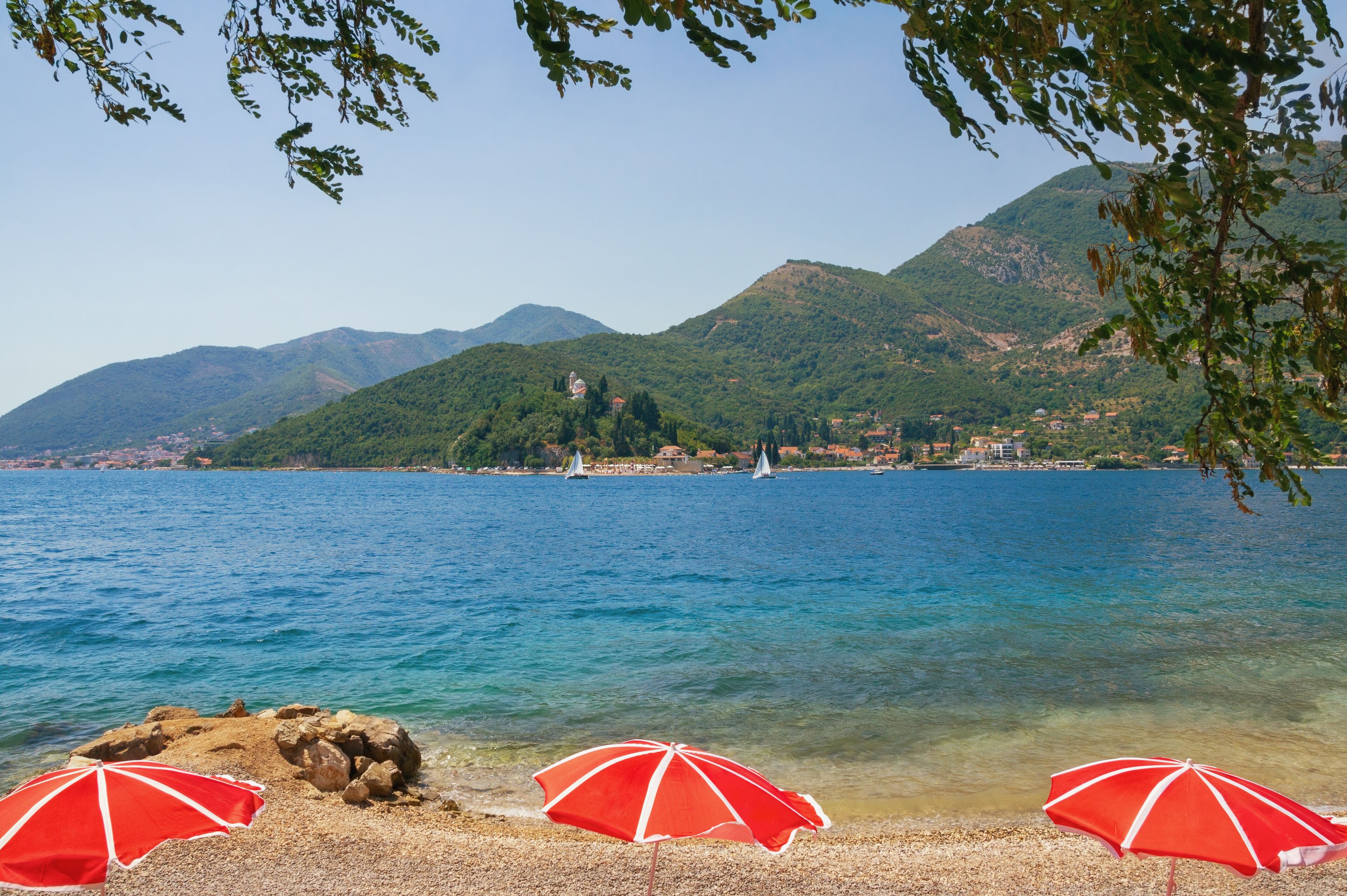 Summer vacations. Beautiful Mediterranean landscape on a sunny day. Montenegro, Adriatic Sea. View of the Bay of Kotor near the Verige Strait, the narrowest part of the Bay of Kotor