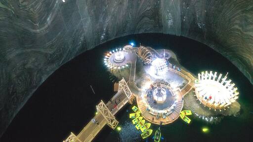 The walls on this cavern shines from the salt content.
http://www.alwayswanderlust.com/deep-underground-in-transylvanias-subterranean-theme-park-salina-turda/
