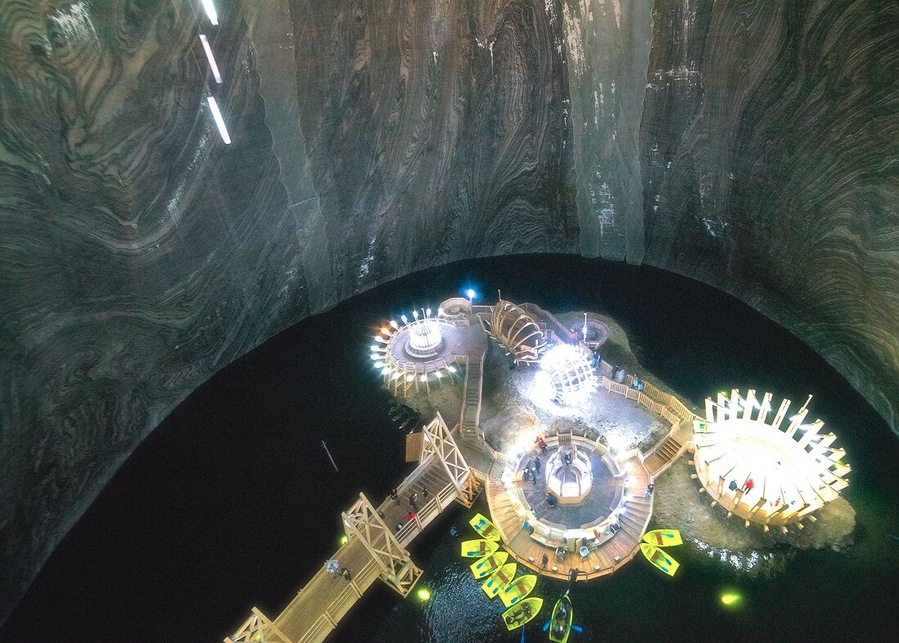 The walls on this cavern shines from the salt content.
http://www.alwayswanderlust.com/deep-underground-in-transylvanias-subterranean-theme-park-salina-turda/