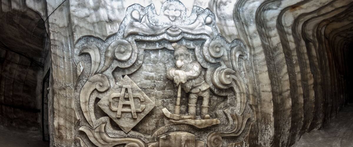 A detailed stone carving with a central figure and intricate designs.