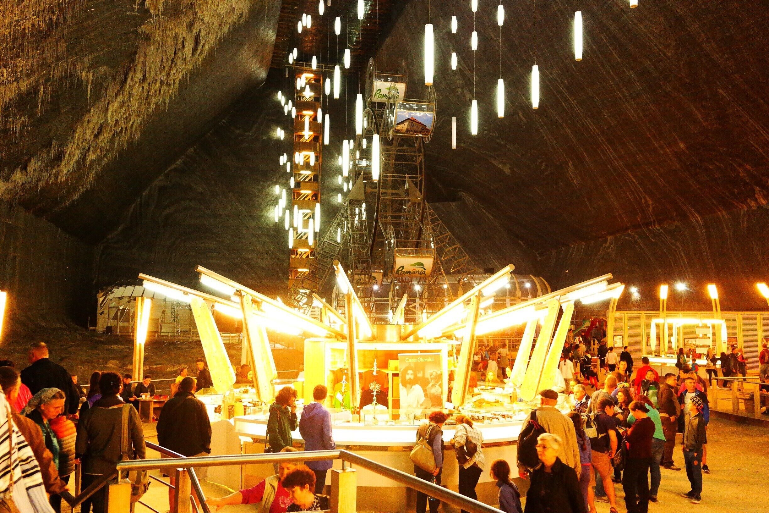 Rudolf mine...

42 meters deep, 50 meters wide and 80 meters long, Rudolf mine is the last place where salt was exploited in Turda. Through the compartment of access, 172 steps lead to the mine hearth.On the walls of each of the 13 "floors" is marked the year when the respective level was exploited. On the north-western ceiling formed over the years salt stalactites, some even three meters long. The panoramic elevator offers tourists an overview of the whole mine...