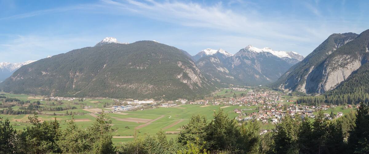 A mountainous landscape with a town nestled in a valley.