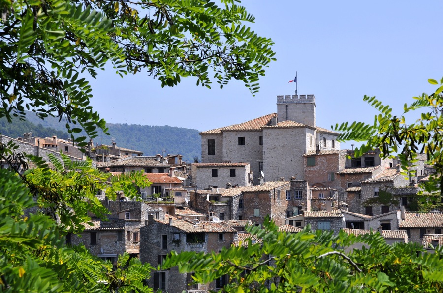 Village of Tourrettes sur Loup in southeastern France with leaves in the foreground, department des Alpes Maritimes