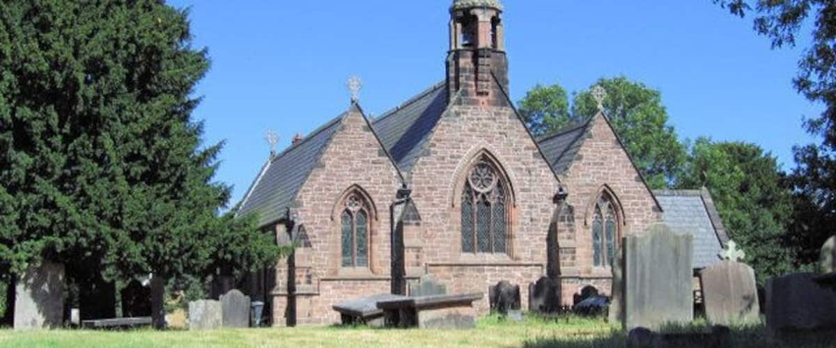 A church with a tall steeple and a clock tower.
