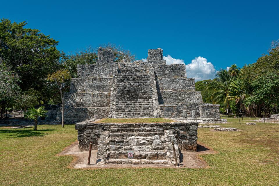 An ancient stone structure with a staircase and a sign indicating no entry.