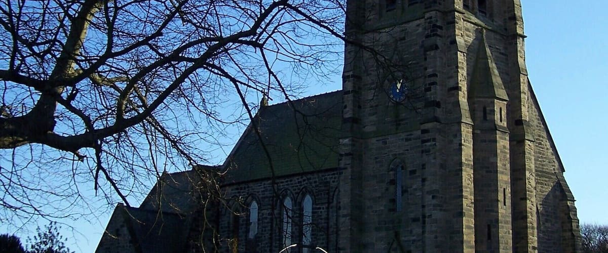 A church with a tall steeple and a clock.