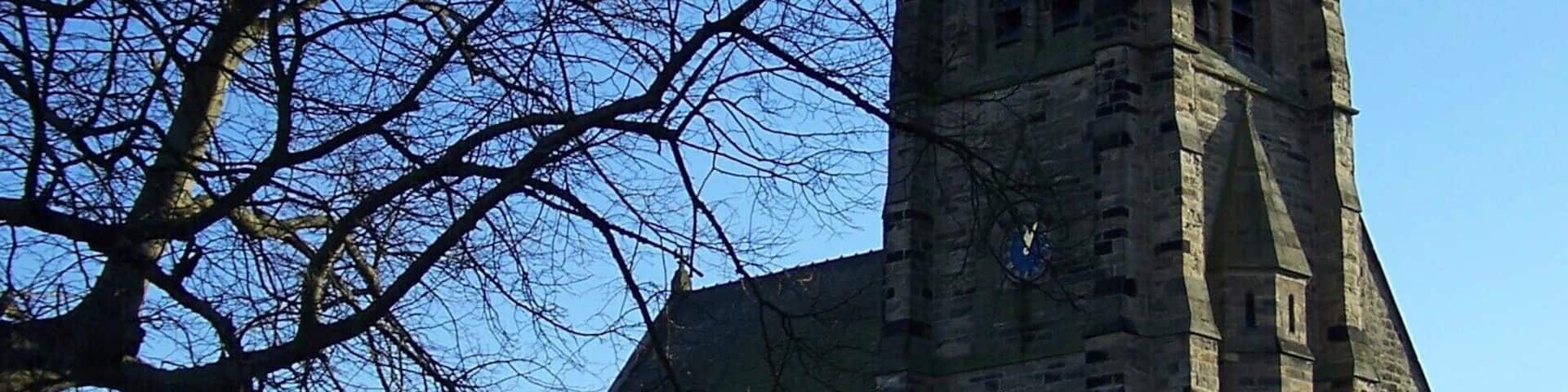 A church with a tall steeple and a clock.