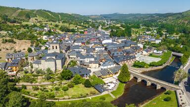 A town with a river, a bridge, and surrounding hills.