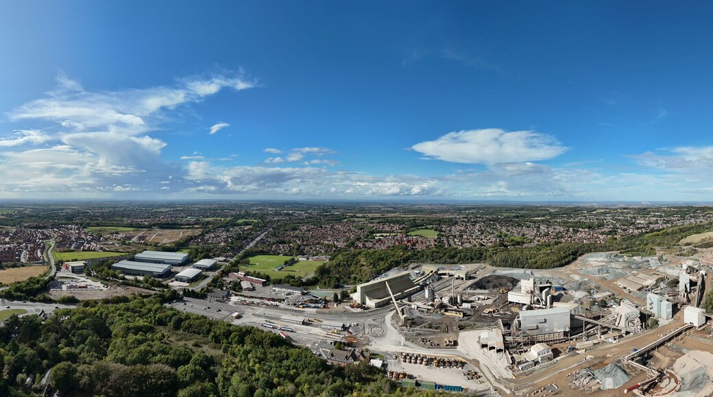 Aerial drone view of heavy industrial aggregates quarry mining site, heavy plant machinery, warehouses, diggers, buildings near Coalville Leicester UK