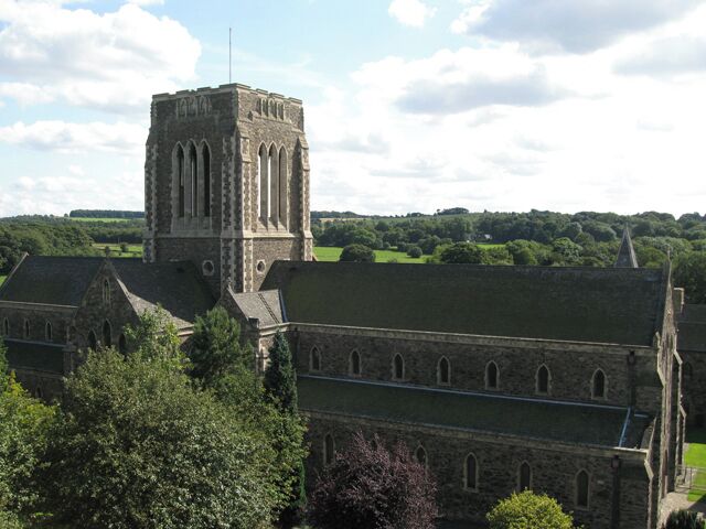 A historic church with a prominent tower and arched windows.