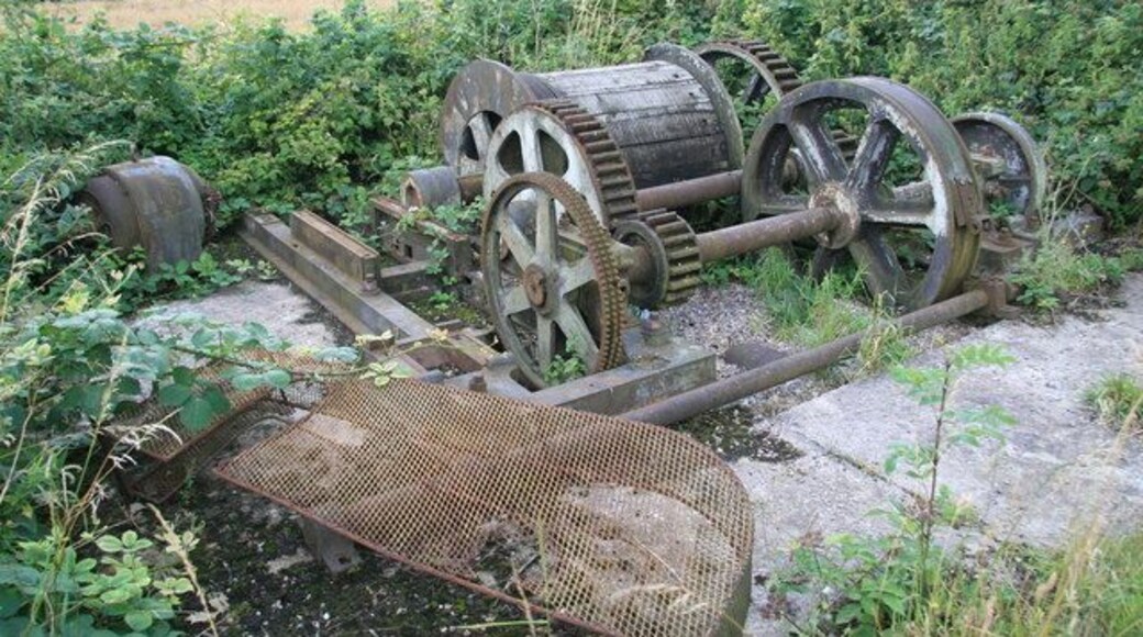 Remains of converted steam winch, Swannington This is at the top of the Swannington Incline and appears to have been relocated here. It was once a double reduction geared twin cylinder steam winch. One disc crank has been replaced by a gear and there is a loose electric motor and chain guard that presumably went with it. The engine has Easton & Tattersall, Leeds cast in the bed - a maker I'm not familiar with.
