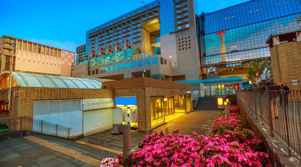 Wide view of Kyoto Tower reflects on glass facade of Kyoto Station building from Karasuma side. Kyoto Station is a major railway station and transportation hub in Kyoto, Japan. Spring season.
