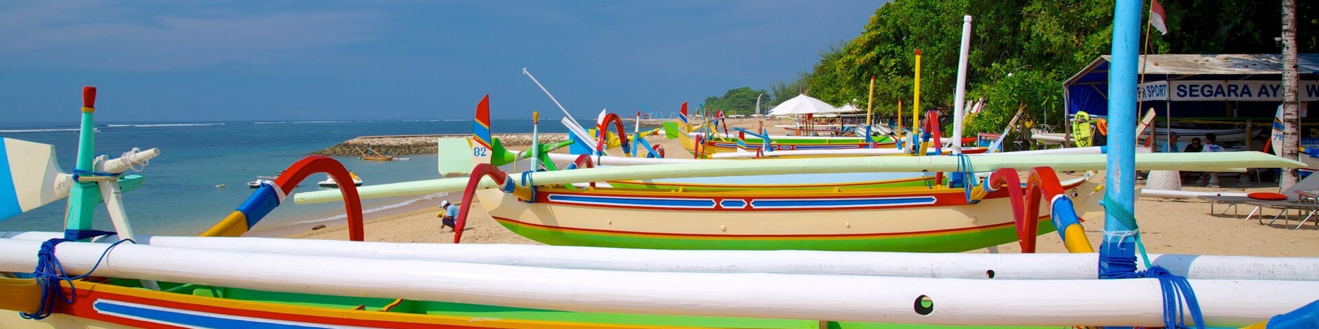 Segara Beach which includes tropical scenes, a sandy beach and boating