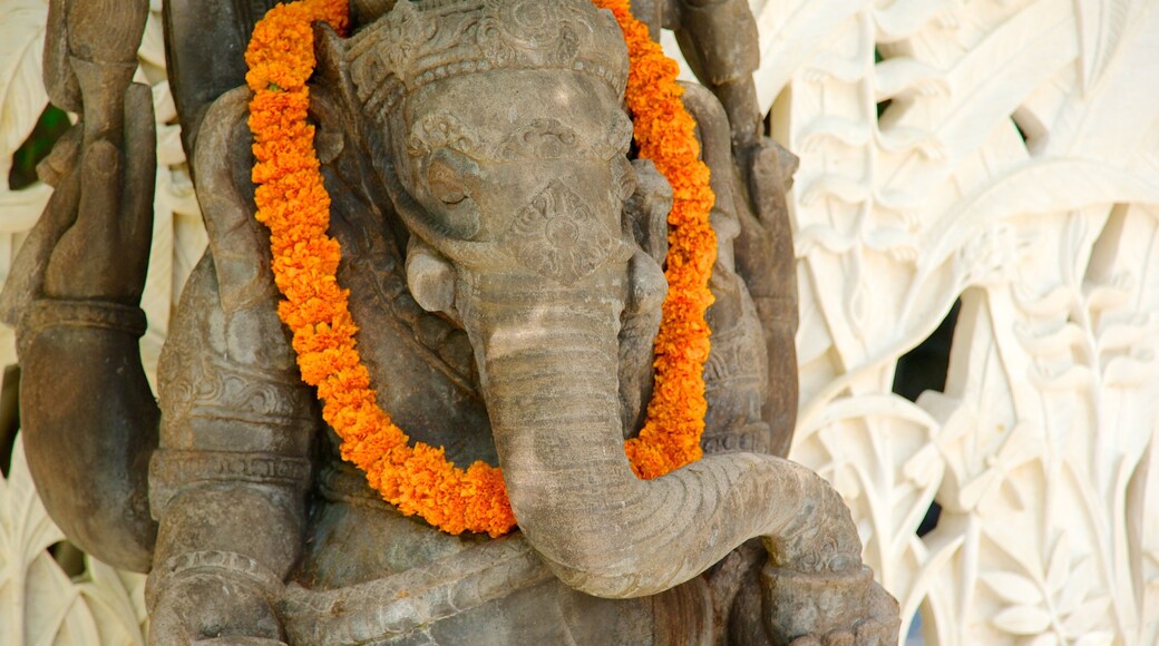 Segara Beach which includes religious aspects and a statue or sculpture